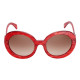 Elsa Lee Paris sunglasses, round frame made of semi-transparent sparkling red plastic, with a gold tone symbol on the temples