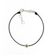 Black cord bracelet with its green peridot stone in a silver close set by Elsa Lee Paris