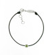 Black cord bracelet with its green peridot stone in a silver close set by Elsa Lee Paris
