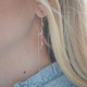 Elsa Lee Paris - Boucles d'oreilles pendantes en argent 925 rhodié avec tige et motif liane sur chaîne. 10 oxydes de zirconium 0