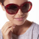 Elsa Lee Paris sunglasses, round frame made of semi-transparent sparkling red plastic, with a gold tone symbol on the temples