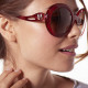 Elsa Lee Paris sunglasses, round frame made of semi-transparent sparkling red plastic, with a gold tone symbol on the temples