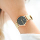 Thin watch in golden metal bracelet and black dial