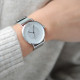 White dial and contemporary designed watch with its Milanese mesh bracelet in silver