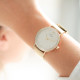 White dial watch with sparkling circle on dial and golden bracelet in Milanese Watch. Interchangeable leather bracelet free. 