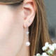 Silver dangling earrings with silver chain, diamond shaped design and soft pink pearl by Elsa Lee Paris 